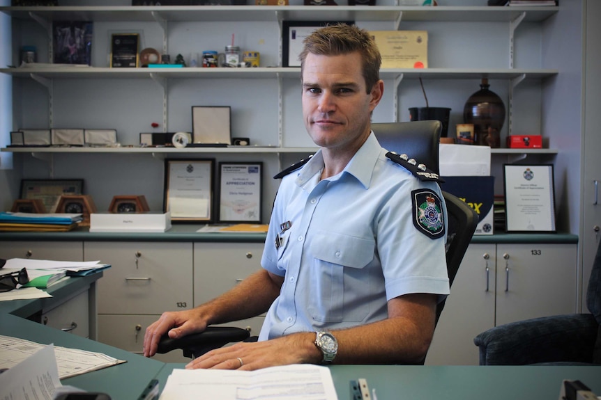 Mount Isa Police Acting Inspector Neil King sitting at his desk.