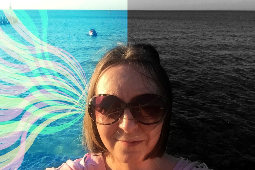 A selfie of Kylie at the beach but half of the background is colourful, the other half is greyscale.
