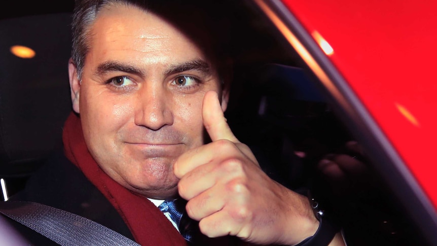 CNN's Jim Acosta gestures as he leaves federal court in Washington.