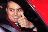 CNN's Jim Acosta gestures as he leaves federal court in Washington.