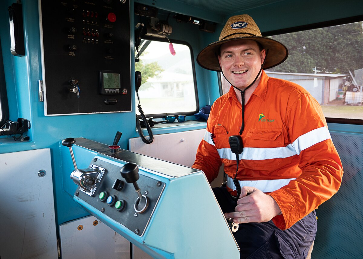 Young man in high vis at controls of train