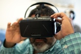 A close-up of a man wearing a virtual reality headset.