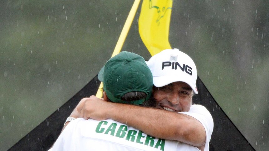Angel Cabrera hugs caddie and son after forcing the Masters to a play-off.