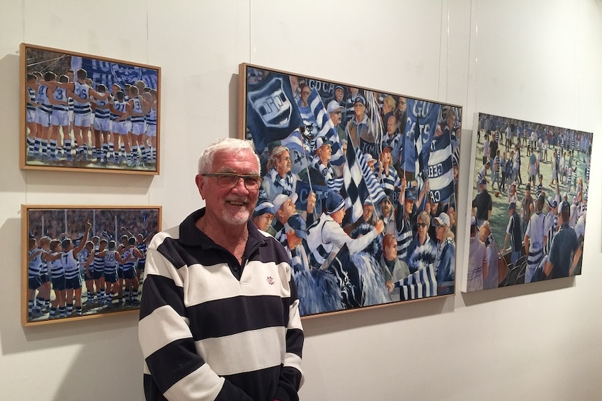 Bob Utber stands in front of painting depicting Geelong Football Club.