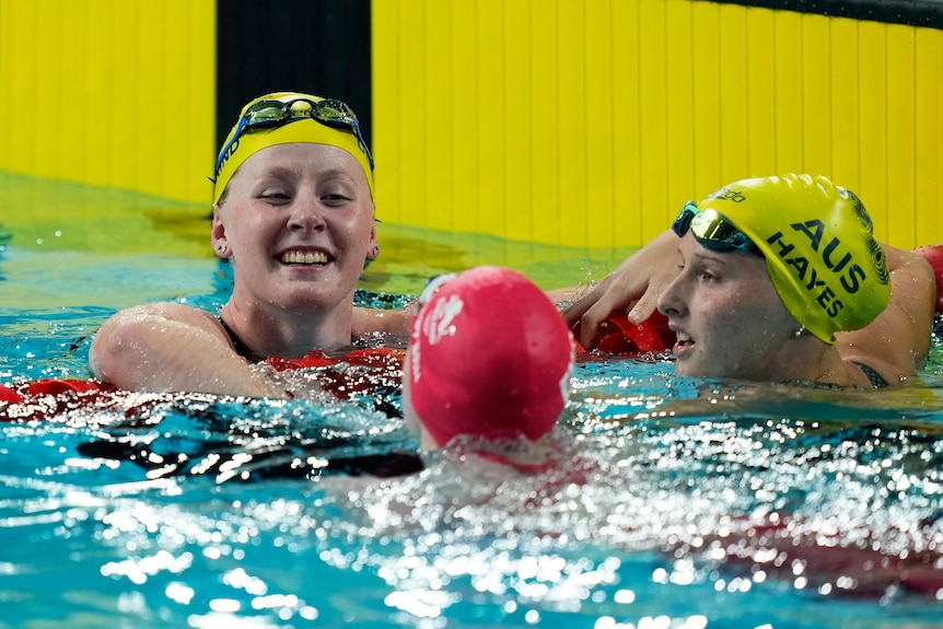 blind swimmer katja dedekind leans over a lane rope smiling after winning gold in a race