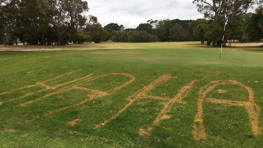 The words "ha ha" written in the grass of a golf green
