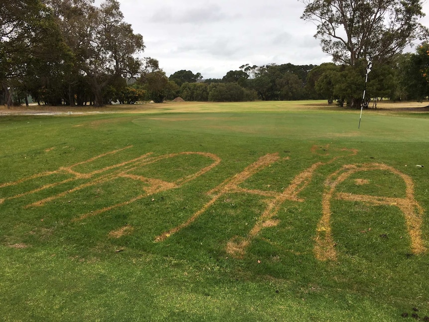 The words "ha ha" written in the grass of a golf green
