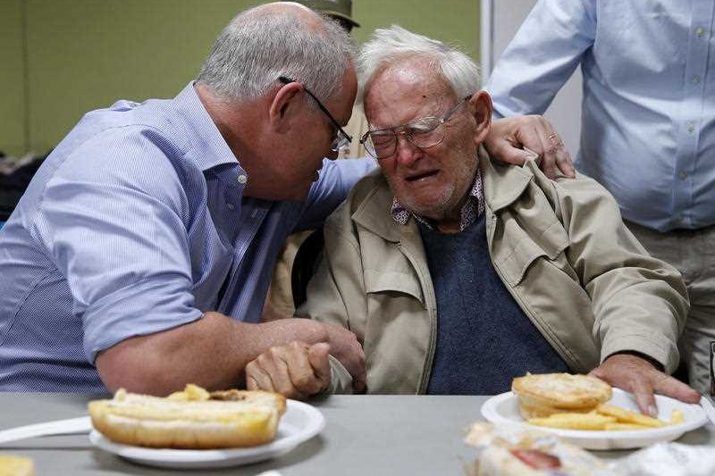 Scott Morrison consoling a crying man.