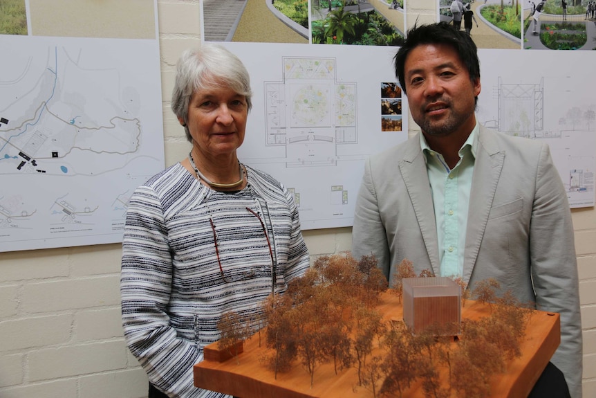 Judy West and John Choi standing behind a model of the winning design for the Ian Potter National Conservatory