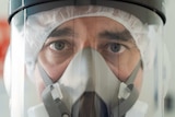 Dr Seas Stevens wearing a face shield and other equipment to protect against COVID-19.