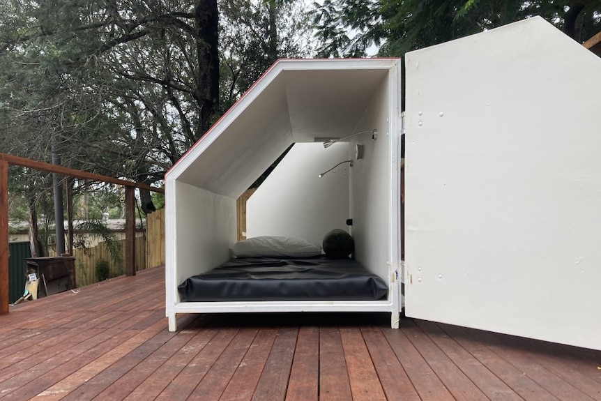 An accommodation pod that contains a mattress and phone charger.