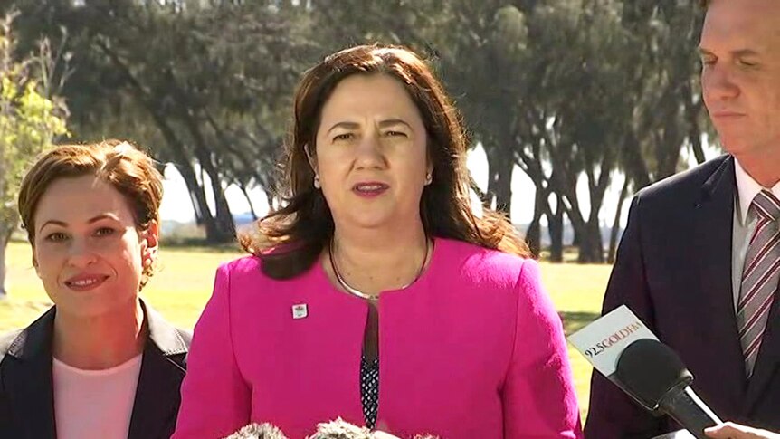 Queensland Premier Annastacia Palaszczuk (centre) speaks to media on Queensland's Gold Coast