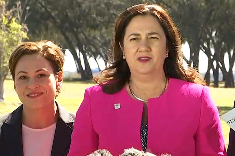 Queensland Premier Annastacia Palaszczuk (centre) speaks to media on Queensland's Gold Coast