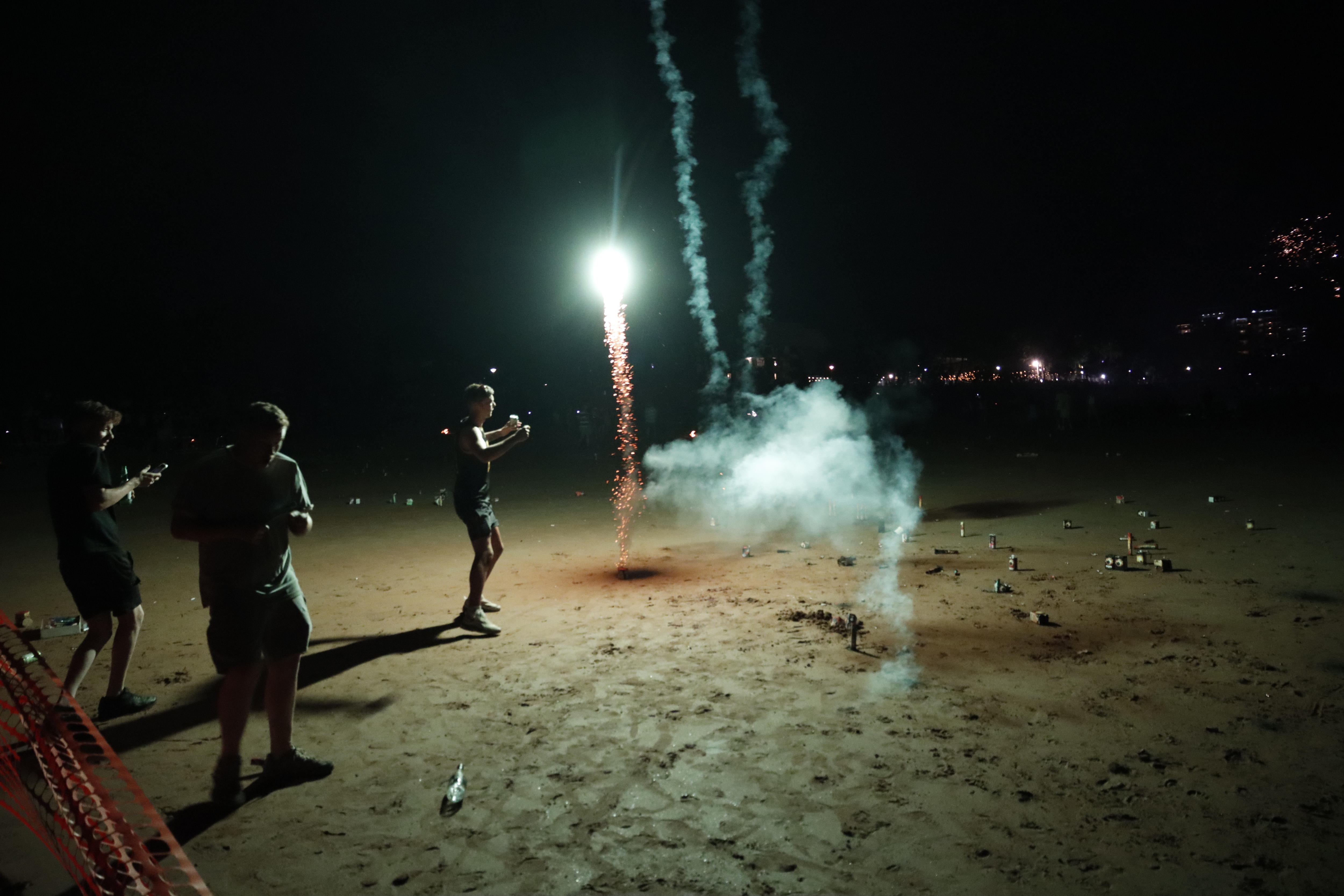 People letting off fireworks on a beach