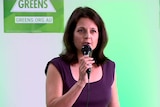 Alison Xamon holds a microphone at the WA Greens launch.