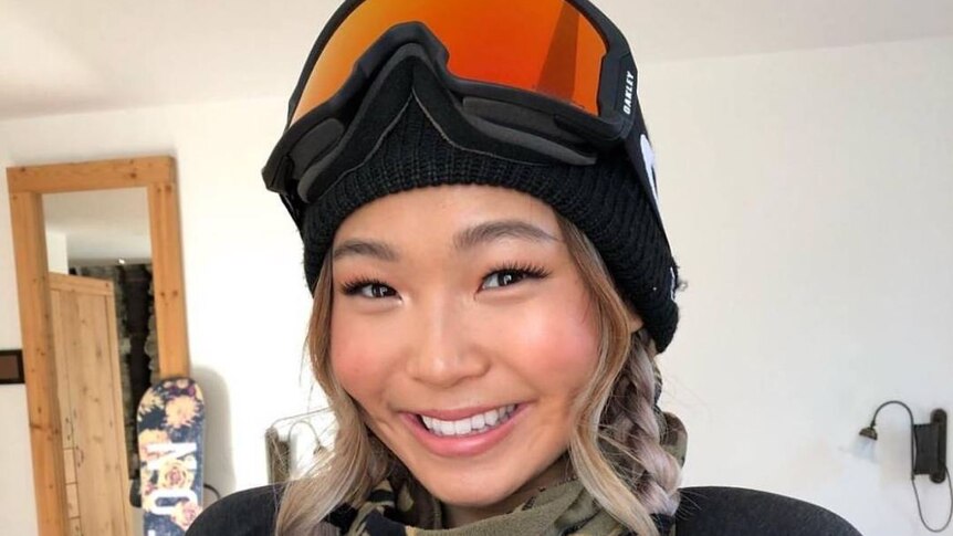 Chloe Kim with goggles on smiling.