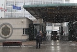 Convoy of vehicles exit the British embassy in Moscow in the snow