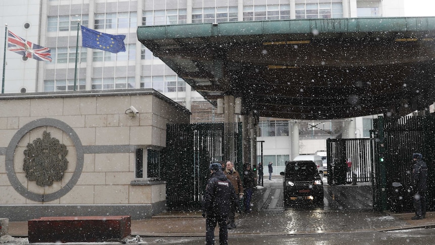 Convoy of vehicles exit the British embassy in Moscow in the snow