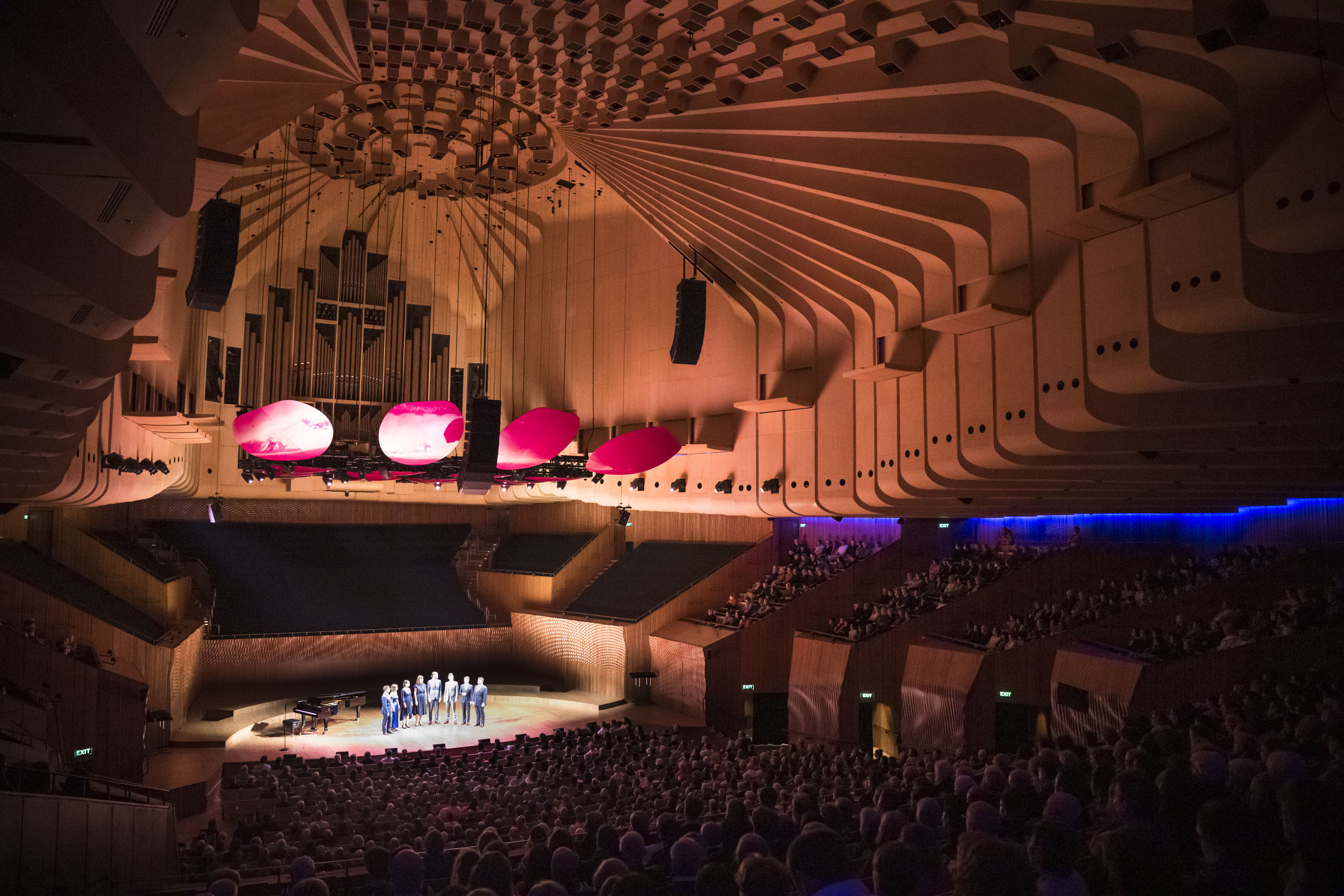 The stage of Sydney Opera House Concert Hall which shows the organ and British ensemble Voces8 performing on stage 