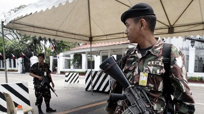 A Philippines Army soldier keeps watch outside the presidential palace in Manila.
