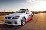 A New South Wales police car parked on the side of a road.