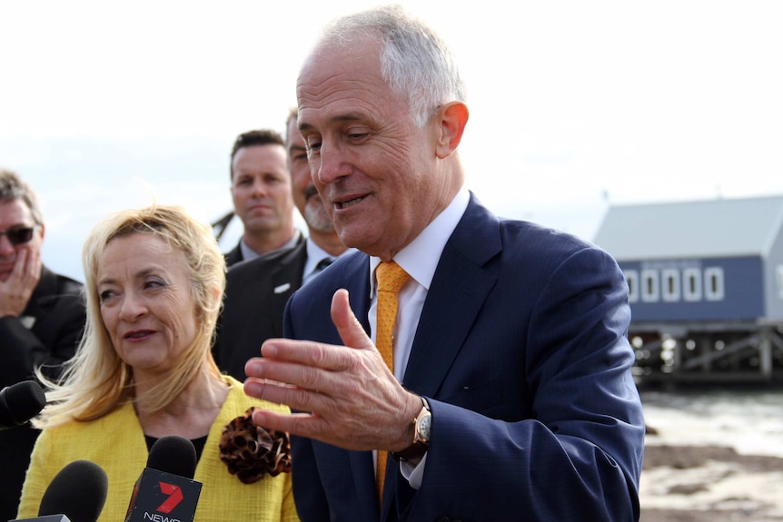 Prime Minister Malcolm Turnbull in Busselton with his hand out talking to reporters.