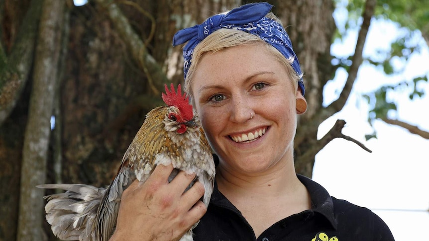 Sugarshine FARM co-owner Fox Stace holds a one-eyed rooster