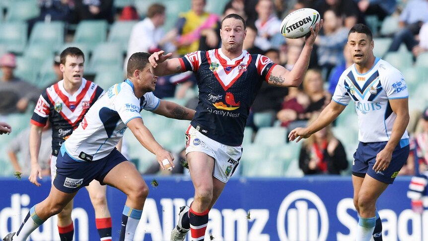 Boyd Cordner running with the ball in his left hand against the Titans.