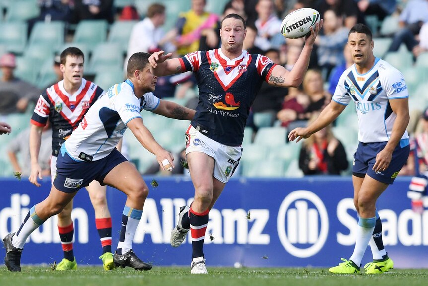 Boyd Cordner running with the ball in his left hand against the Titans.