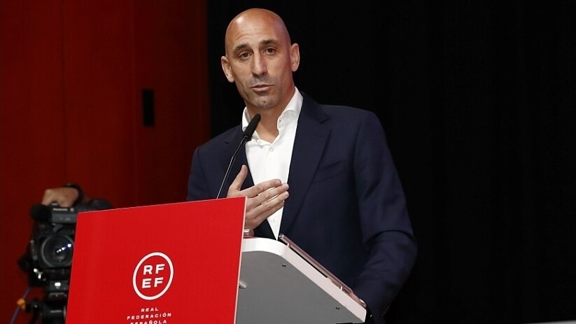 Luis Rubiales stands at a podium