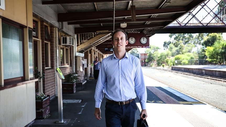 Tim Connors walking on the Bendigo train station platform.