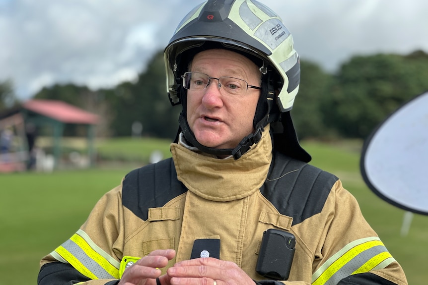 A man with glasses wearing full CFA fire fighting uniform and helmet.