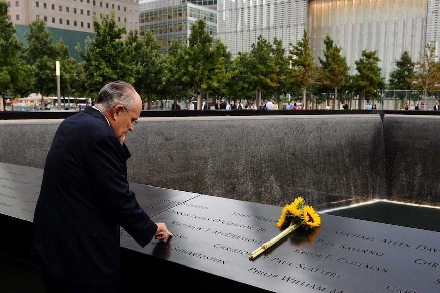 Former New York mayor Rudolph Giuliani stands at the site of the World Trade Centre in New York