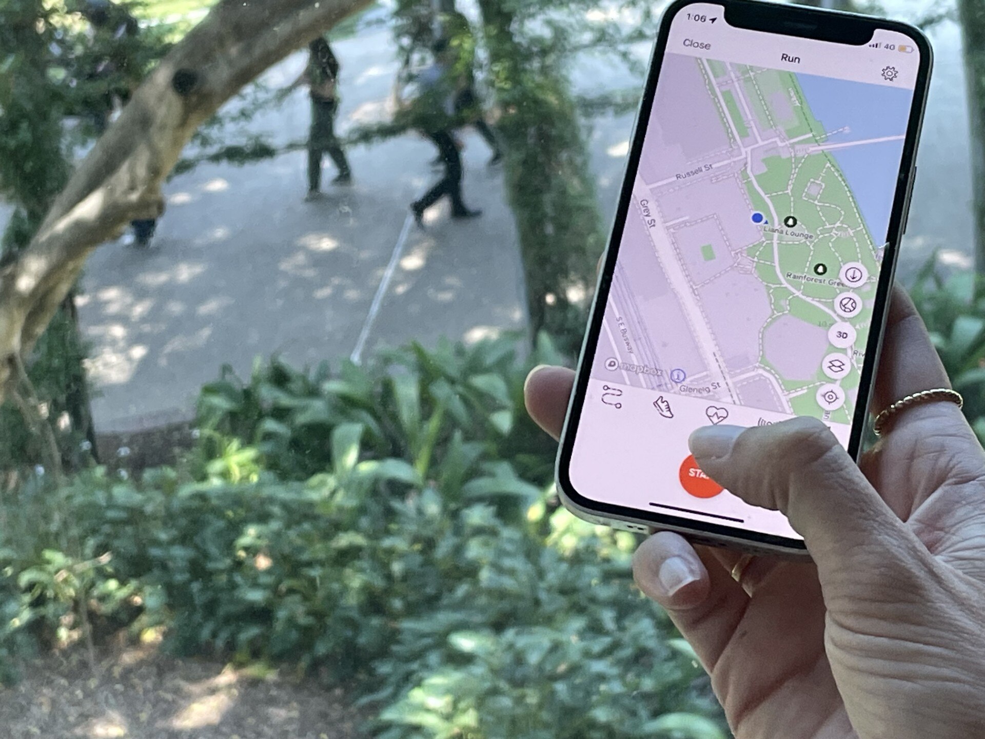 A person holding an iphone with the Strava app open. 