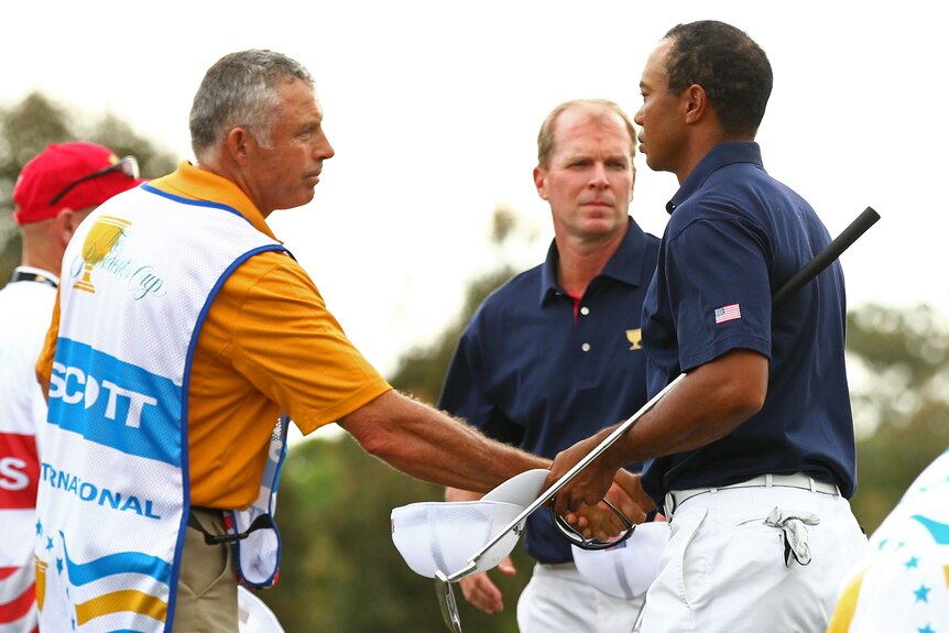 Tiger Woods and Steve Williams defused the media attention surrounding them with an early handshake.