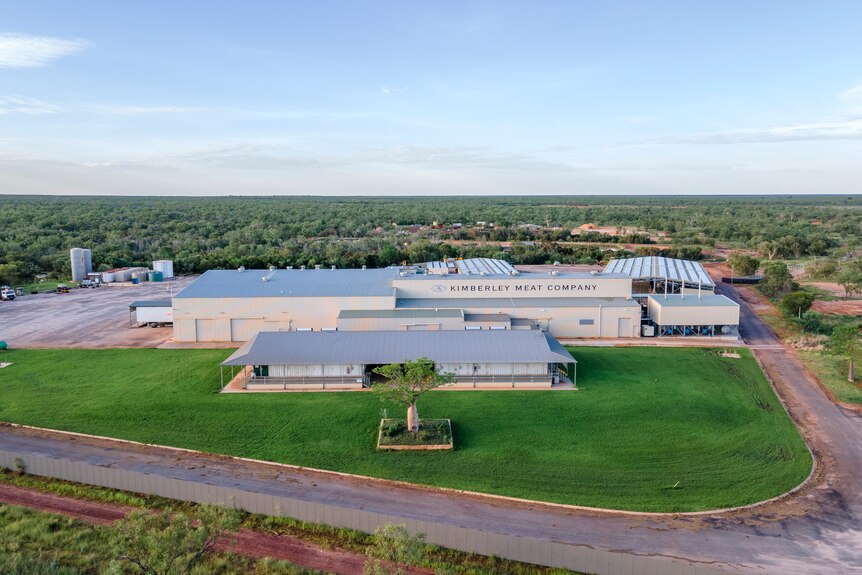 Aerial of processing facility surrounded by green grass