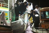 Taiwan policemen inspect bullet holes on the "Guang Ta Hsin 28" fishing boat.
