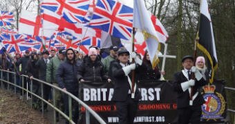 Dozens of Britain First group members march through Telford holding Union Jack flags