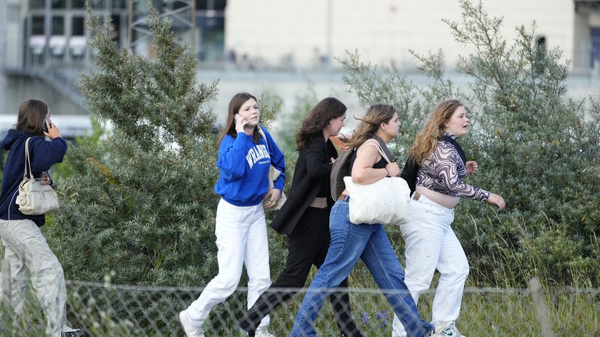 Teens run outside mall post denmark shooting