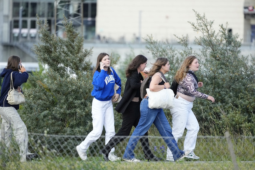 Teens run outside mall post denmark shooting