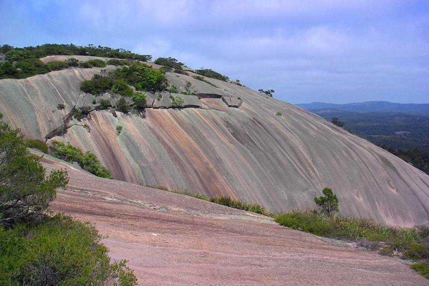 A large, smooth sloping granite rock