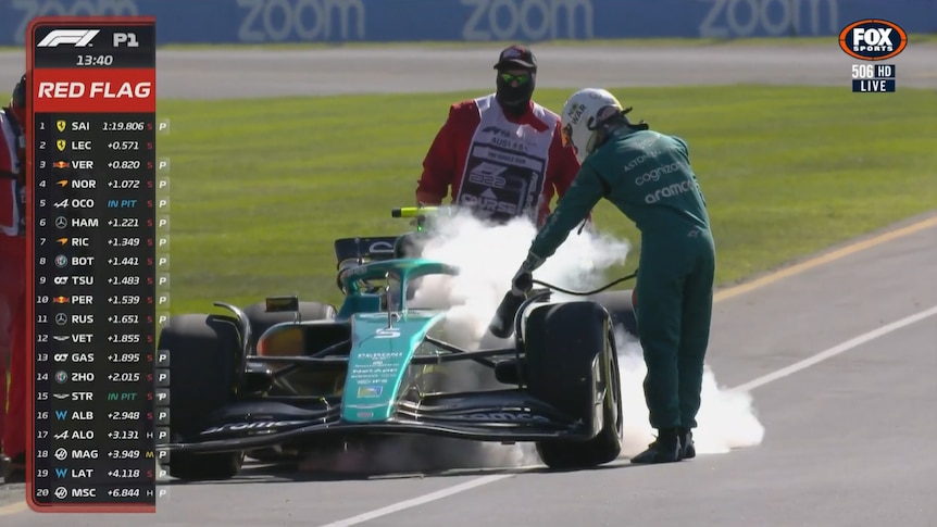 Aston Martin driver Sebastian Vettel blasts his F1 car with a fire extinguisher during practice for the Australian Grand Prix.