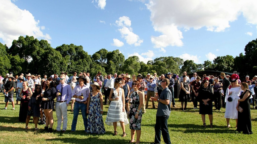 People watch the first horse race on grass at Barcaldine's new turf track