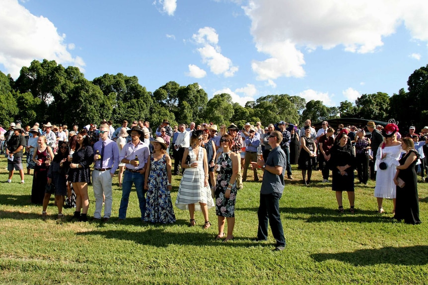 People watch the first horse race on grass at Barcaldine's new turf track