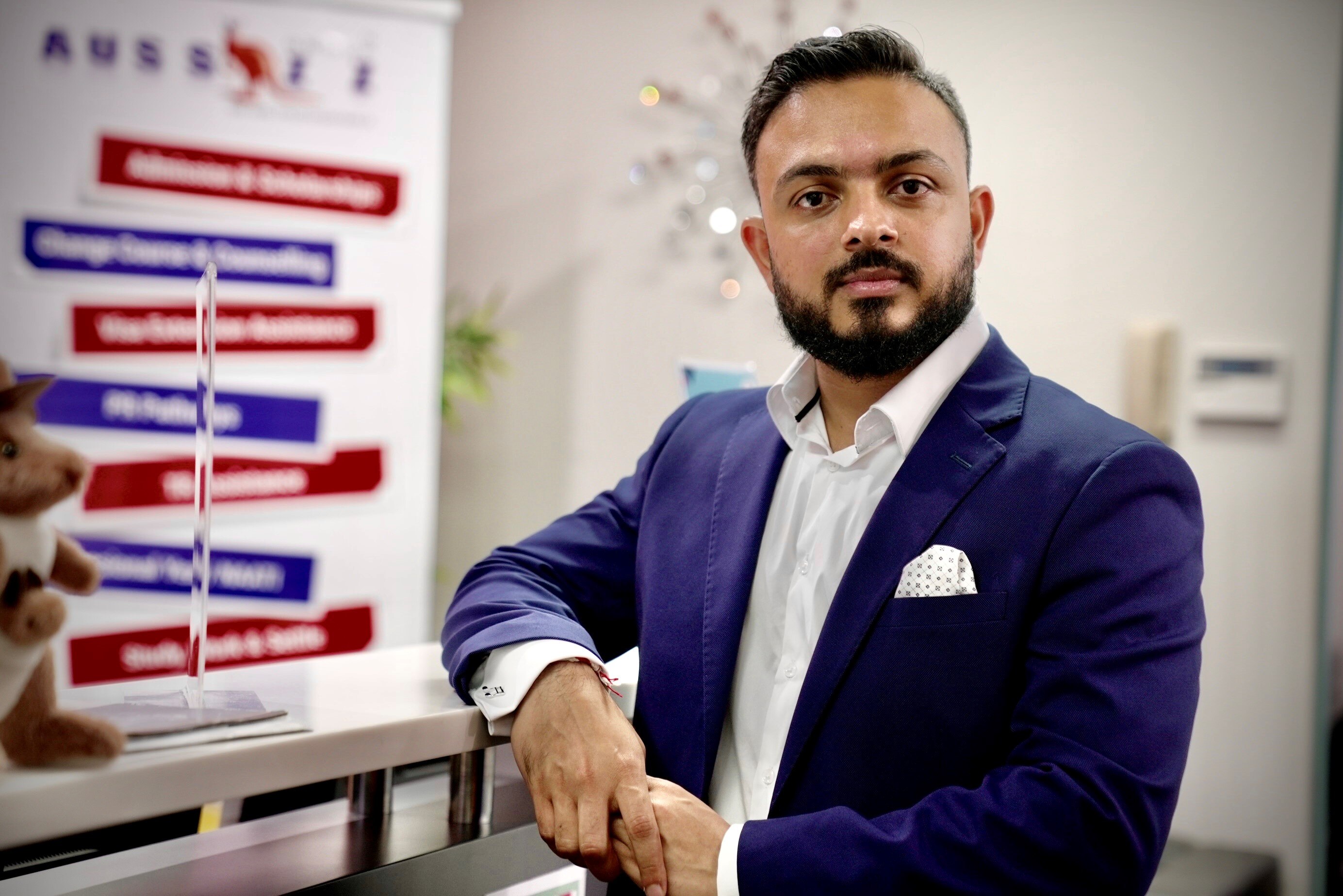 A man in suit stand at a reception.