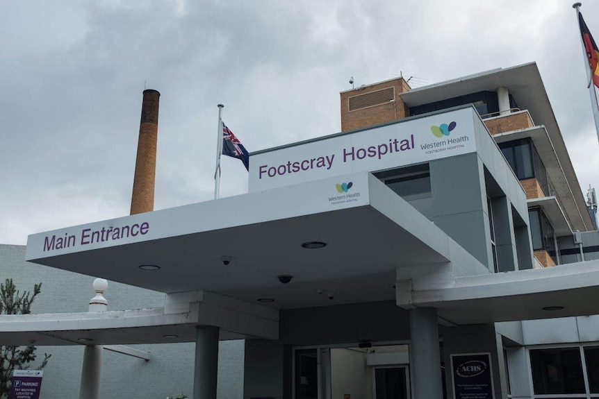 The exterior of Footscray Hospital against a cloudy sky