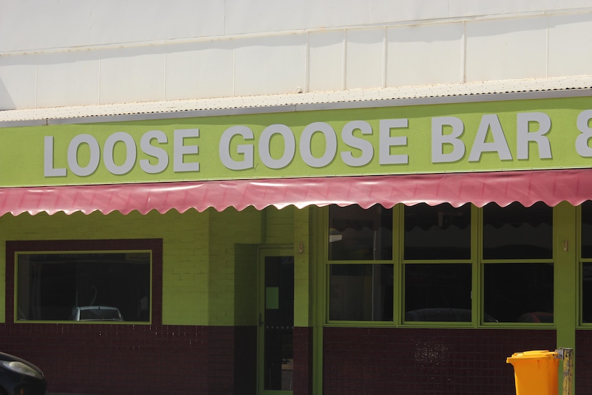 The bar sign in white lettering with a lime green background