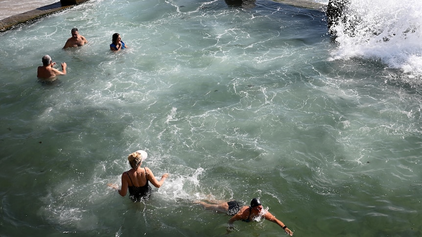 swimmers cool off at coogee beach side pool during a hot sydney day 