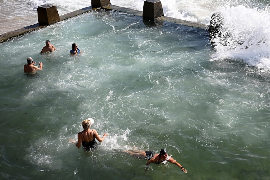 swimmers cool off at coogee beach side pool during a hot sydney day 