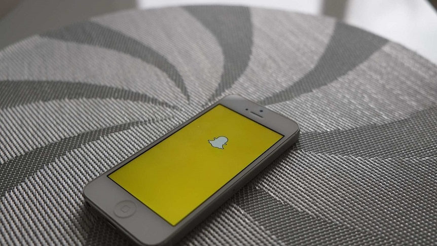 Snapchat app loaded onto an iPhone, sitting on a surface